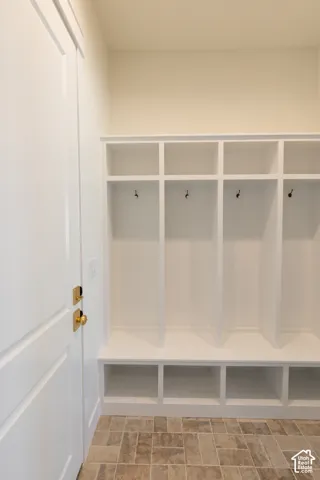 Built-in white cubbies featuring hooks and shelving