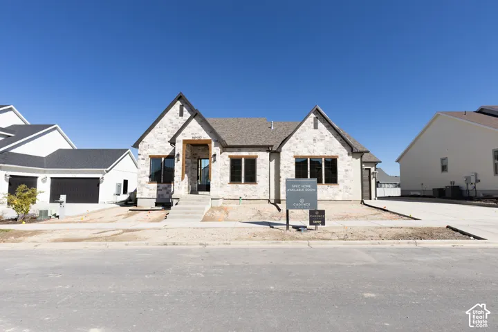 Stone veneer exterior with dark-trimmed windows