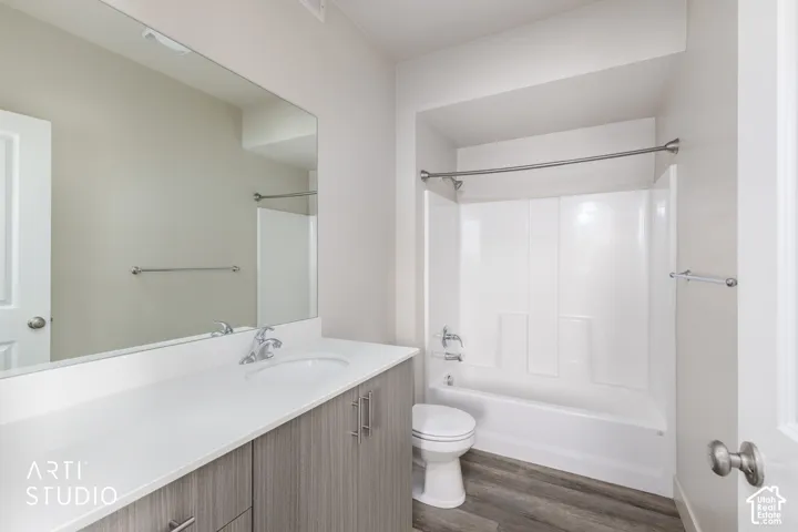 Modern vanity with wood-finish cabinetry, white countertop, and integrated sink