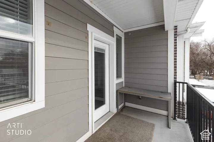 Private exterior balcony with gray horizontal siding
