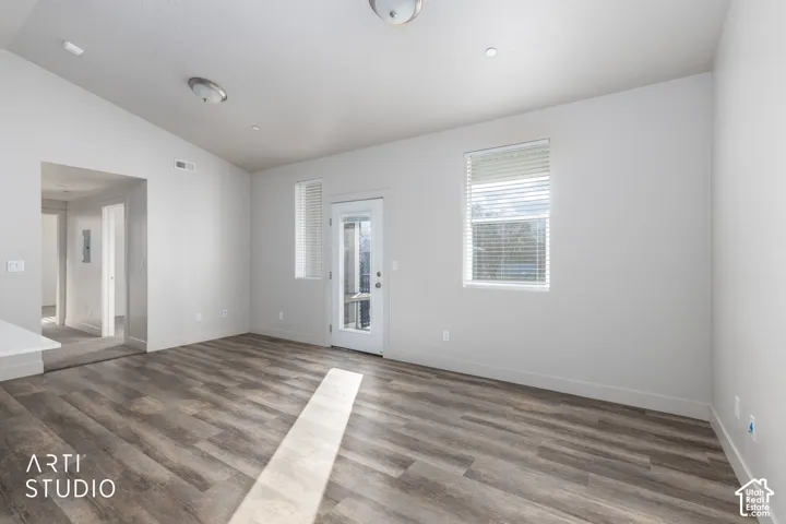 Wood-finish flooring throughout, white painted walls, and ceiling-mounted light fixtures