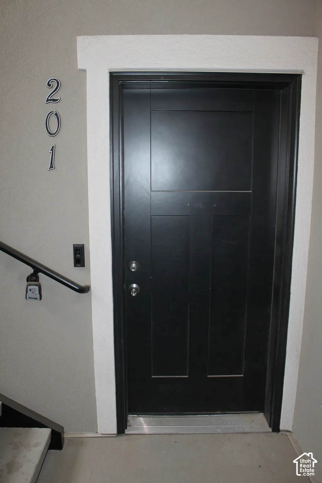 Black paneled front entry door with white trim
