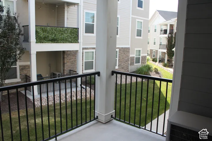 Private balcony with a concrete surface and black metal railing