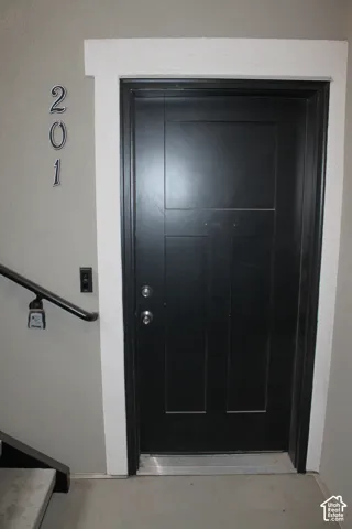 Black paneled front entry door with white trim