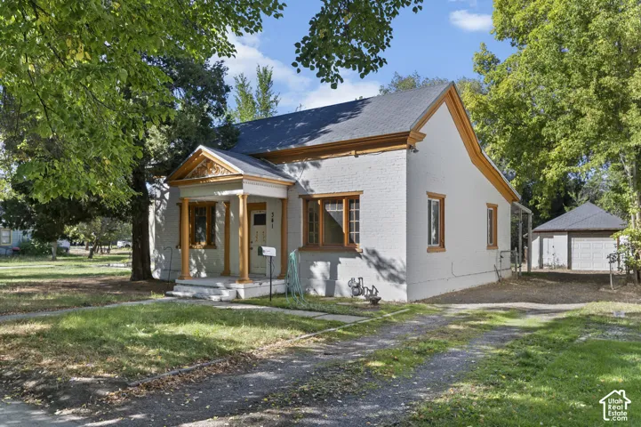 Brick exterior with a covered front porch featuring decorative columns and trim