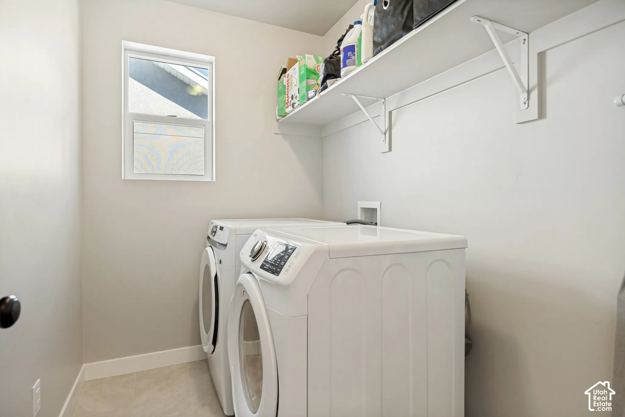 Wall-mounted shelving with white brackets, white-framed window, and light-toned flooring