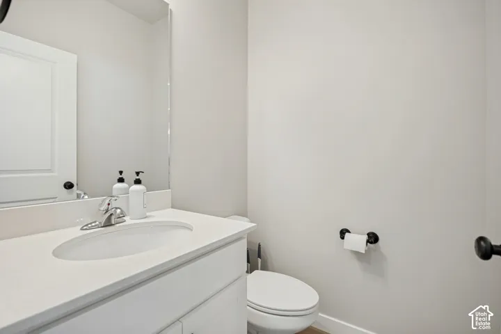 Vanity with a polished chrome faucet, under-mount sink, and light-toned countertop