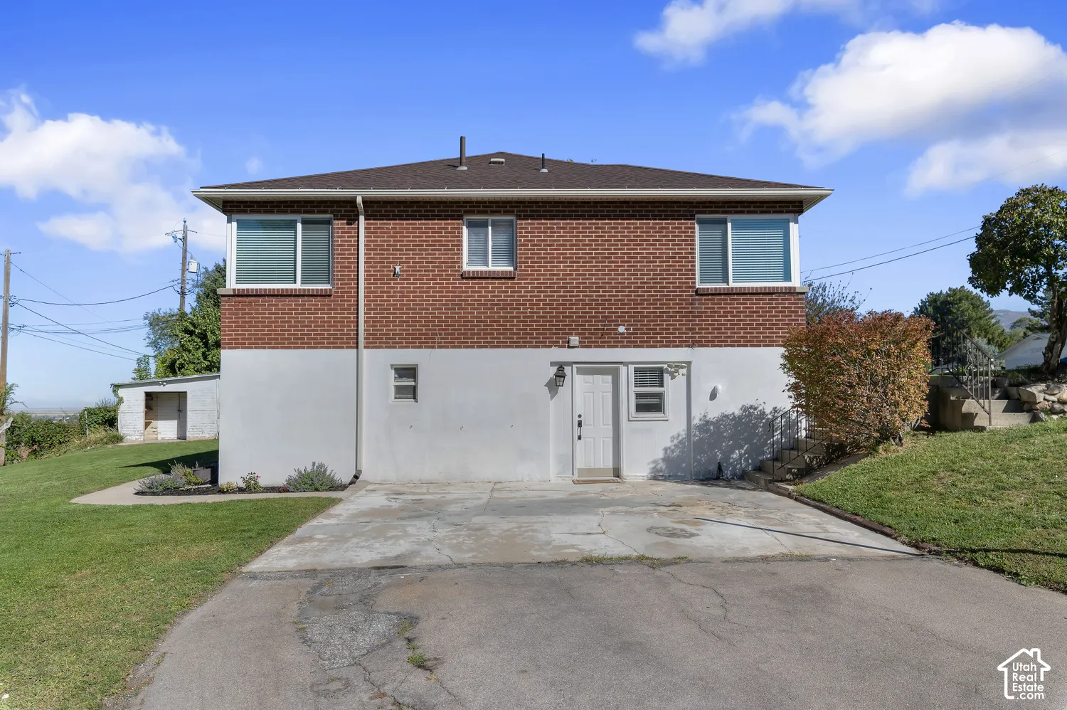 Brick and stucco exterior with multiple windows