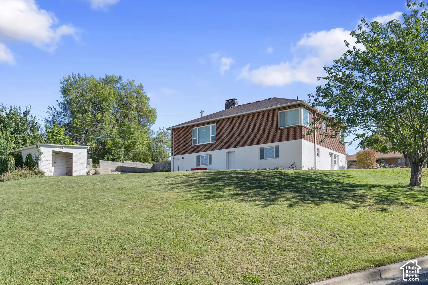 Multi-level residence featuring brick and painted siding