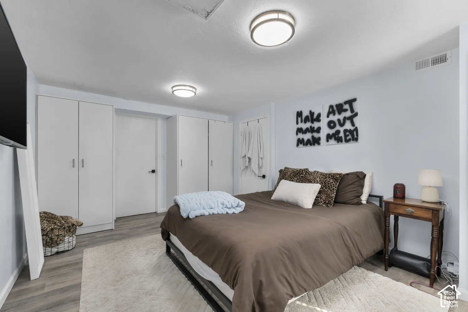 Recessed lighting, wood-finish flooring, and multiple built-in storage units