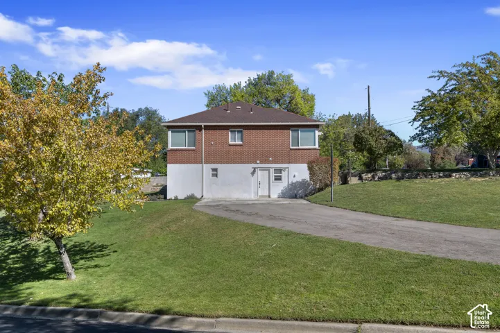 Brick and stucco exterior with multiple windows