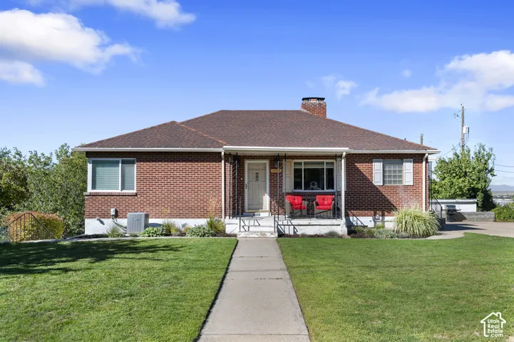 Brick exterior with a brown shingle roof