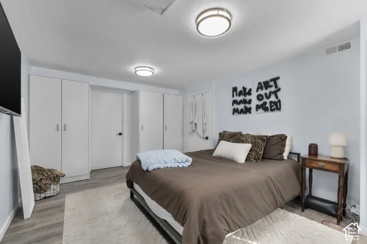 Recessed lighting, wood-finish flooring, and multiple built-in storage units