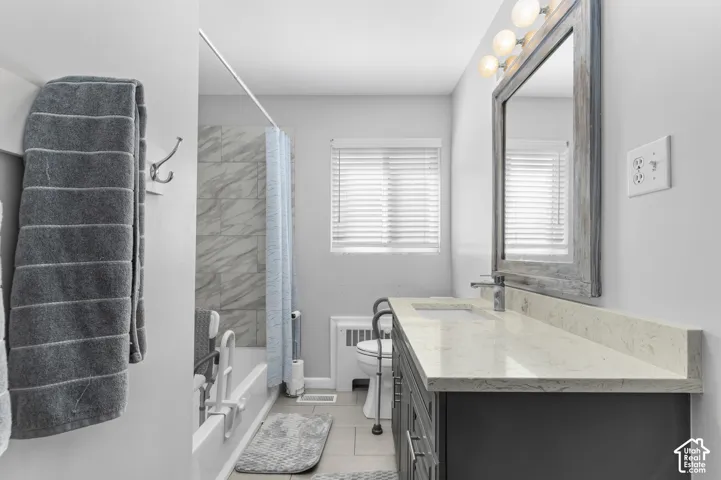 Vanity with light-toned countertop, undermount sink, and chrome faucet