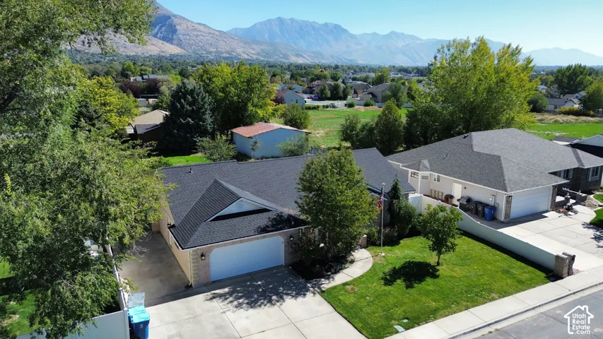 Contemporary exterior with a dark shingle roof, attached garage, and a concrete driveway
