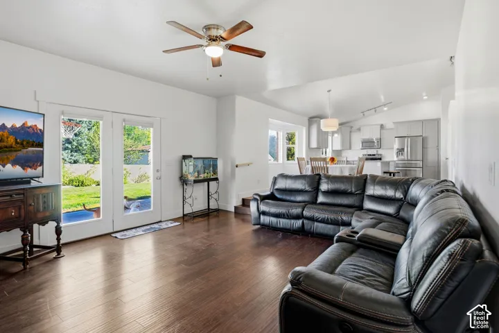 Hardwood-finish flooring throughout, bright white walls, and a ceiling fan with integrated lighting