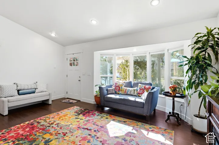 Hardwood-finish flooring, recessed lighting, white walls, and a bay window