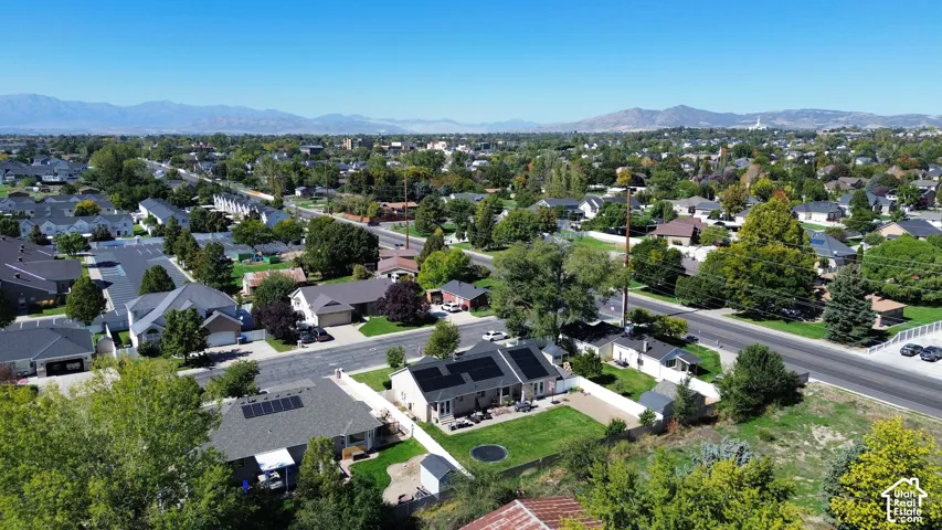 Residential area featuring a variety of single-family homes, mature trees, and mountainous scenery
