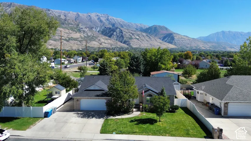 Expansive paved driveway leading to an attached two-car garage