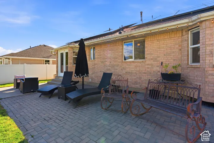 Brick exterior with multiple windows and a patio door