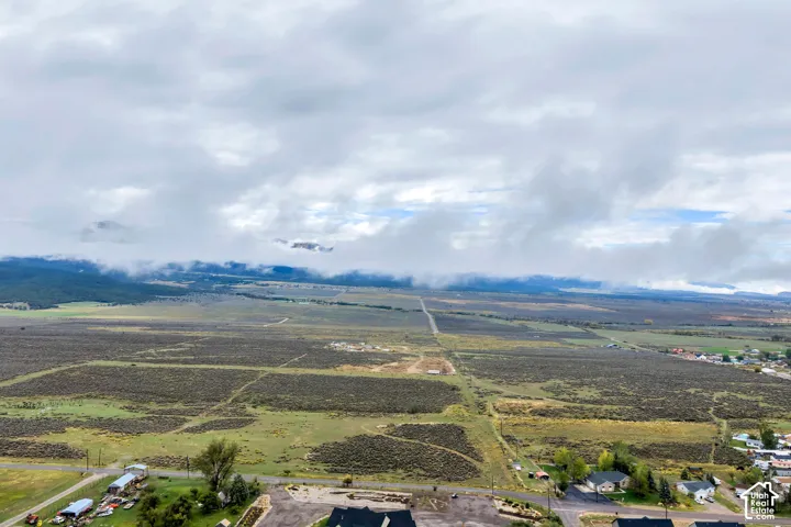 Expansive land area featuring diverse vegetation and distant mountain ranges