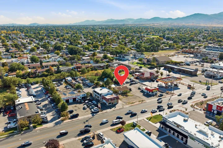Aerial perspective showcasing a commercial property in a developed area, surrounded by mixed-use buildings and residential zones