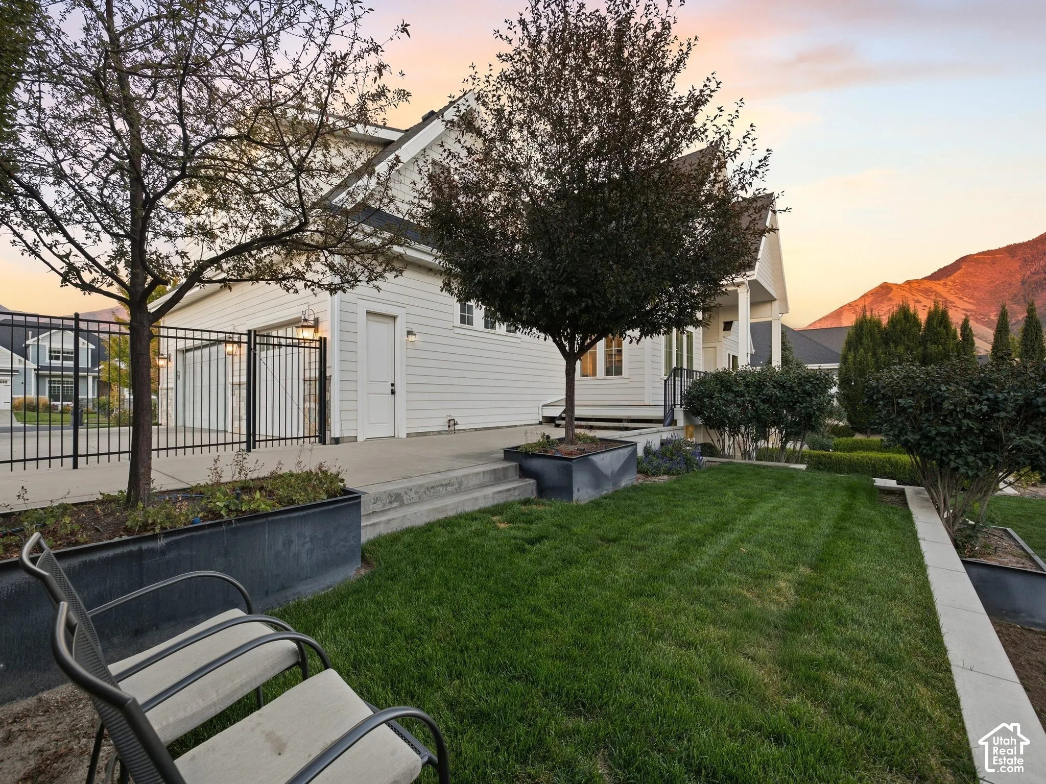 Manicured lawn with concrete retaining walls and integrated planters