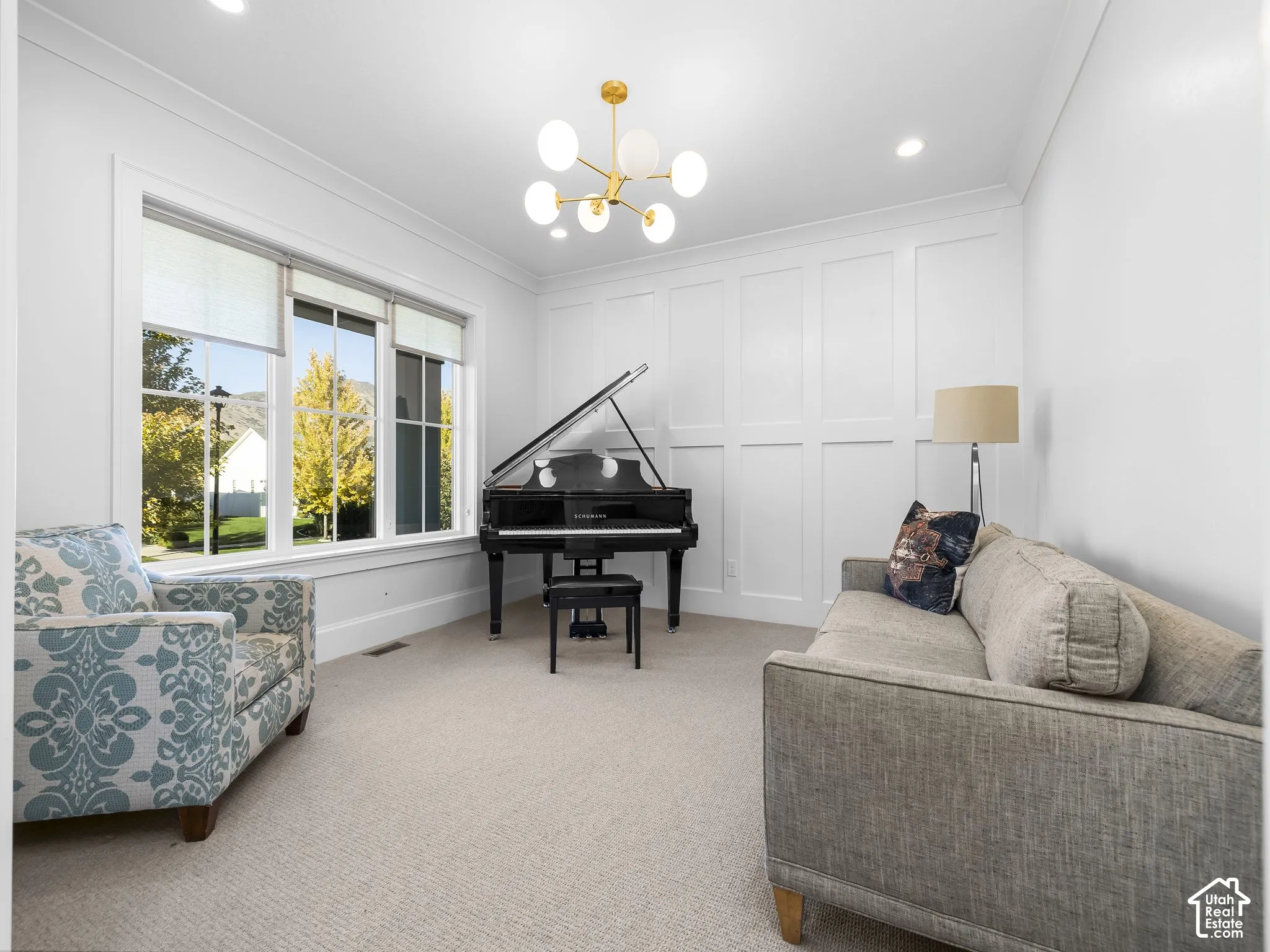 Expansive triple window, elegant wainscoting, recessed lighting, and a contemporary chandelier