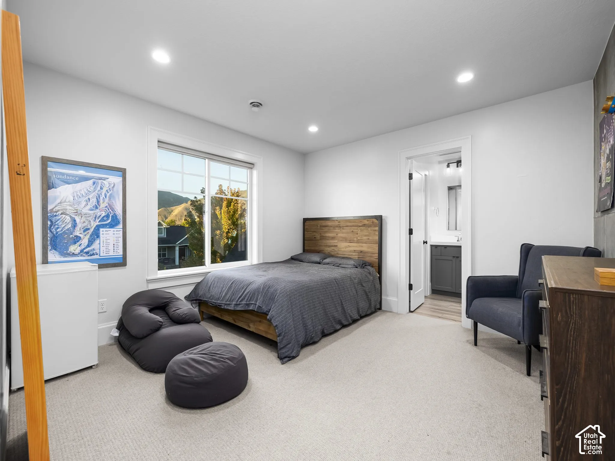 Recessed ceiling lighting, carpeted flooring, and a large window with natural scenery