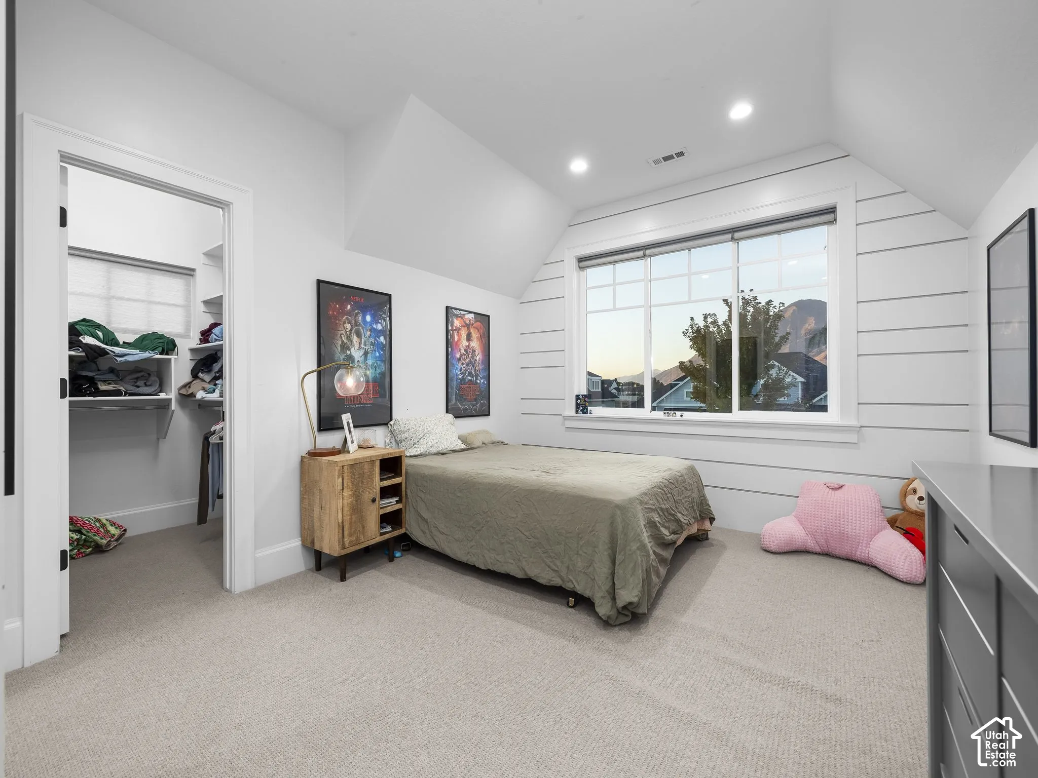 Recessed lighting, large window with integrated blinds, built-in closet shelving, shiplap accent wall, and neutral carpet