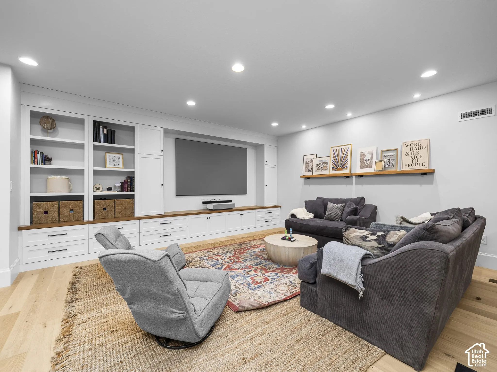 Built-in media center with white cabinetry and wood-finish countertops