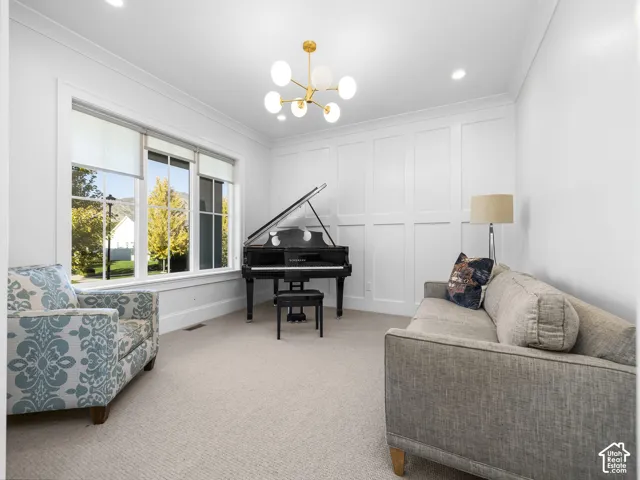 Expansive triple window, elegant wainscoting, recessed lighting, and a contemporary chandelier