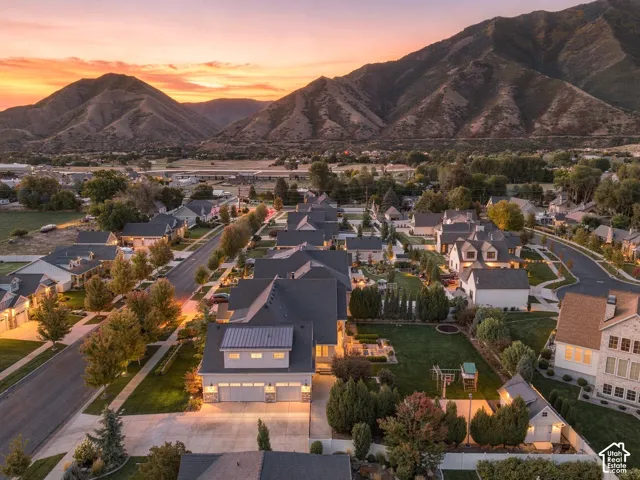 Mountain backdrop with expansive community landscaping, including mature trees and manicured lawns