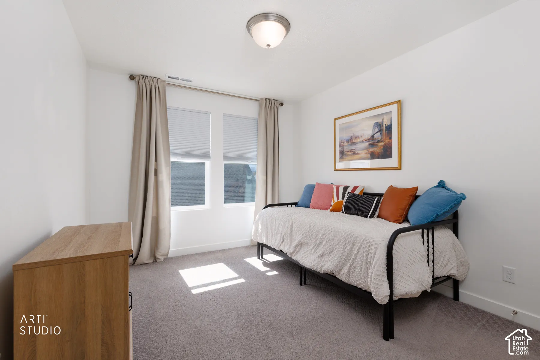 Dual windows with cellular blinds and drapery rods, flush mount ceiling light, and light gray wall-to-wall carpeting