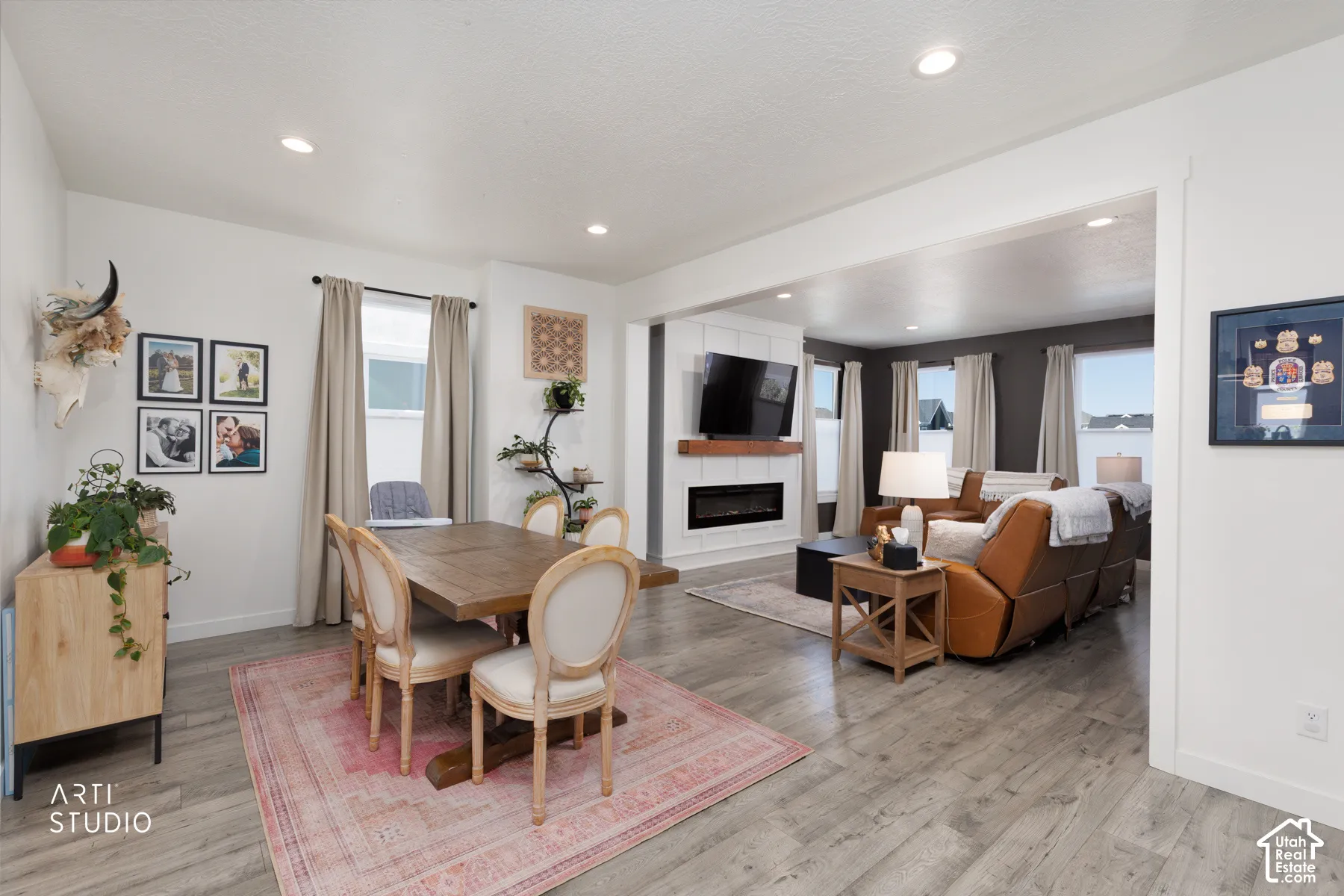 Wood-finish flooring throughout, recessed lighting, and a dining area