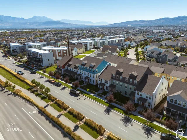 Townhome community featuring multi-story residences, varied exterior finishes, and established landscaping