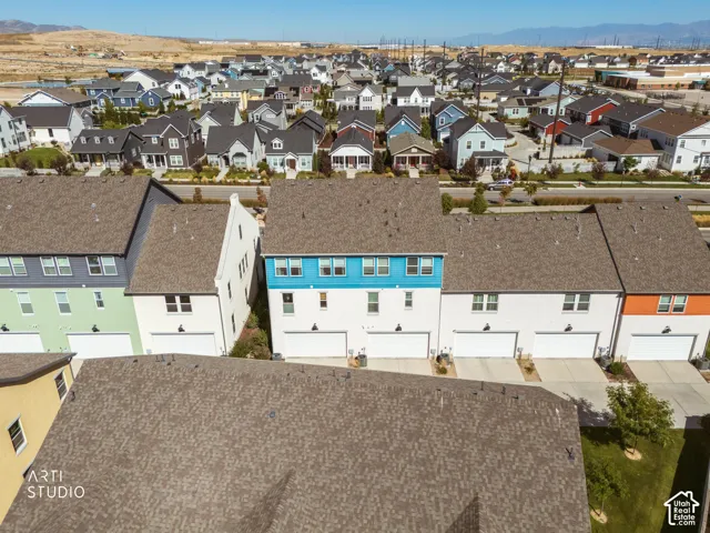 Residential neighborhood with a variety of multi-story homes, multiple attached garages, and paved driveways