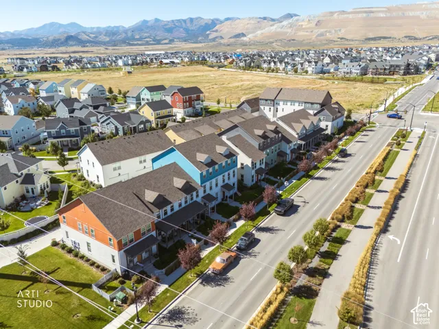 Expansive neighborhood featuring various architectural styles, well-maintained streets, and distant mountain ranges