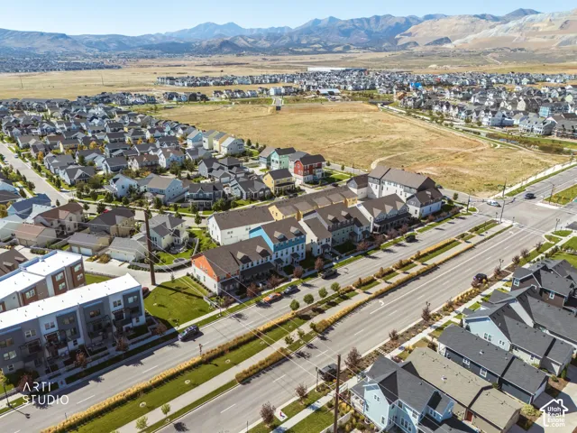 Expansive neighborhood with diverse residential structures, paved roads, and manicured landscaping
