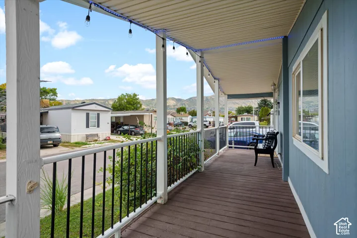 Expansive covered porch with wood-finish decking and white railings