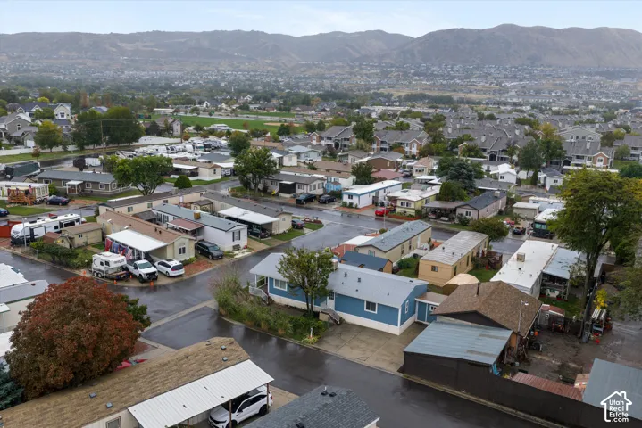 Mountain range backdrop, residential community setting, paved streets, mature trees