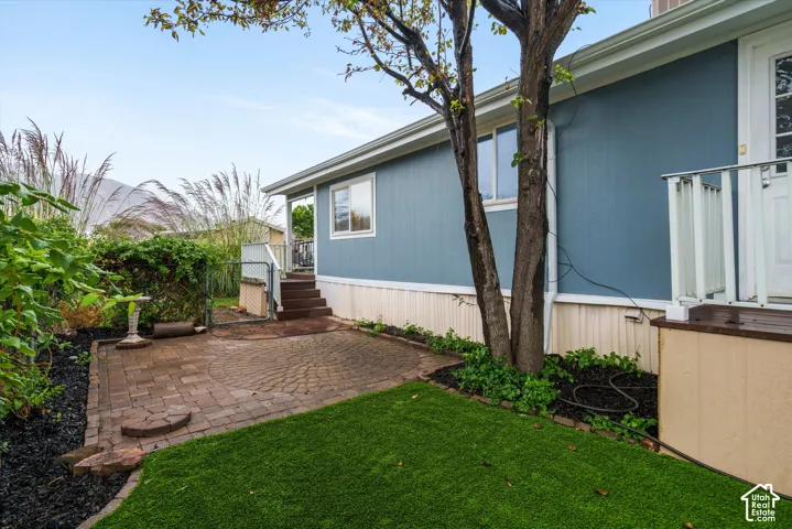 Fenced area of yard, by side entrance.