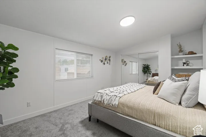 Primary Bedroom #1 Bedroom featuring built-in shelving, mirrored closet doors, and a