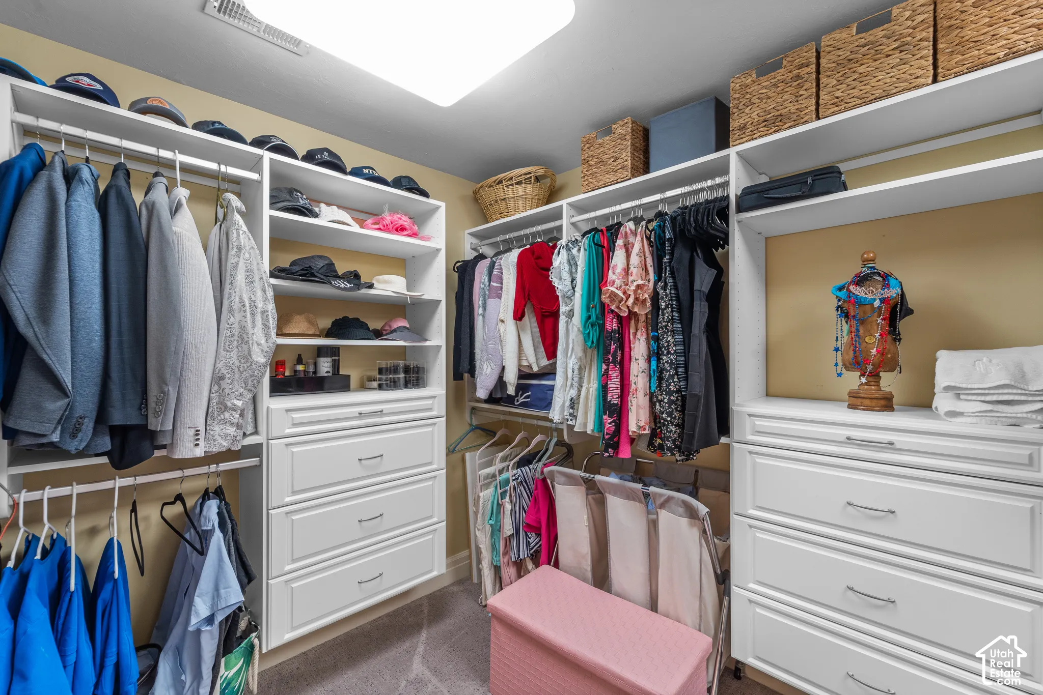 Walk through bathroom and into the closet. Custom shelves, drawers and hanging rods are both functional and elegant.