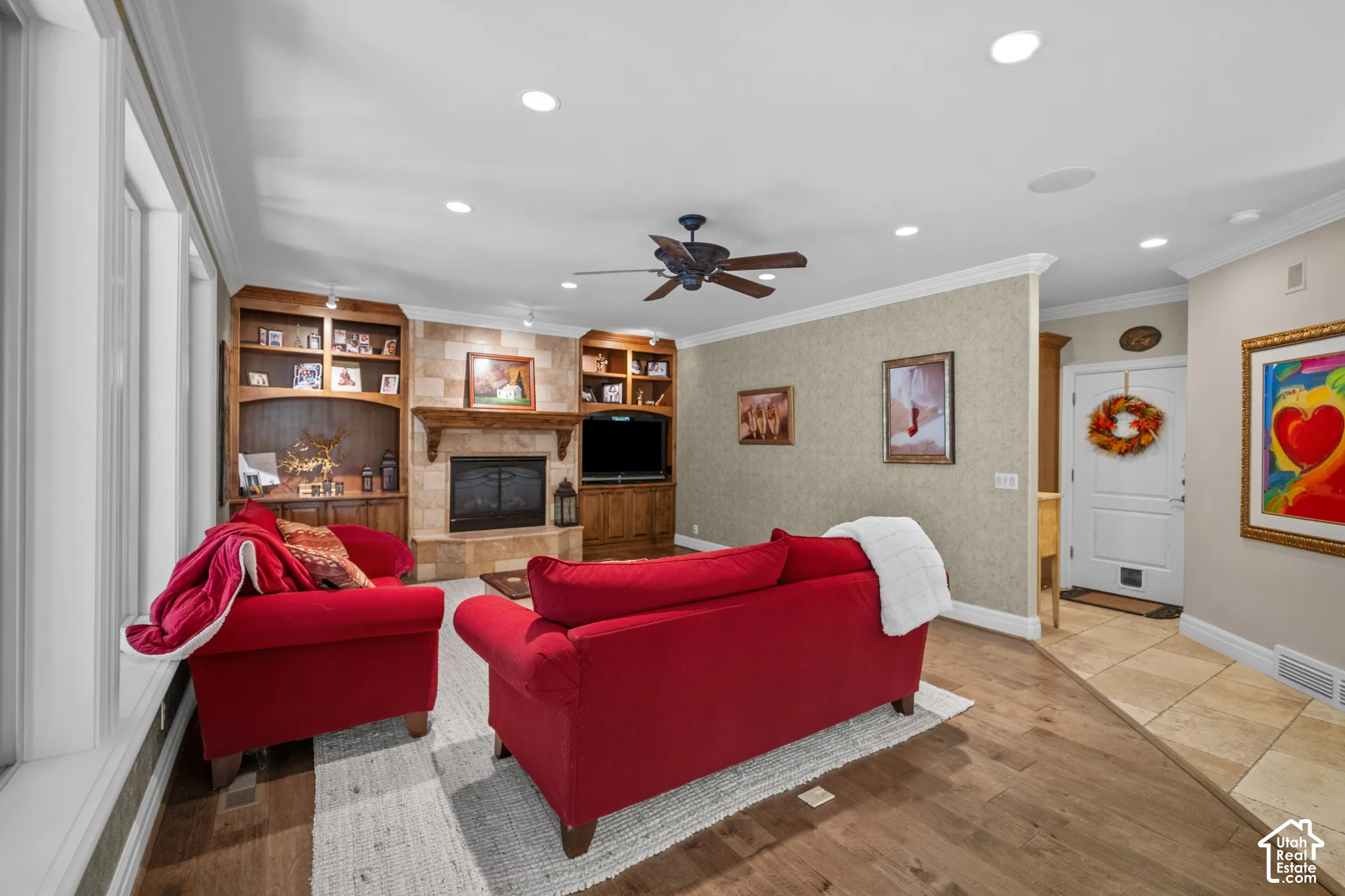 Custom wood flooring replaces the tile as you move into the great room. Built in shelves and fireplace make this room both cozy and beautiful.
