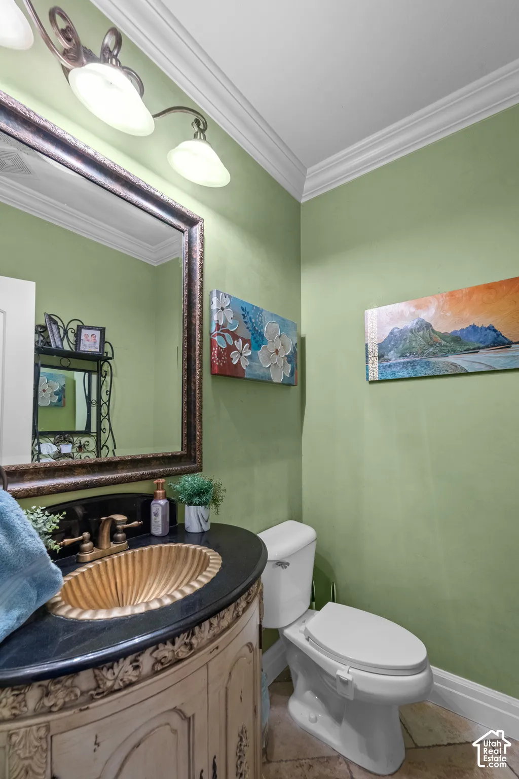The main floor Powder room is soothing with it's soft sage-green walls, while the vessel sink and ornamental cabinetry base give it a classic warm feeling.