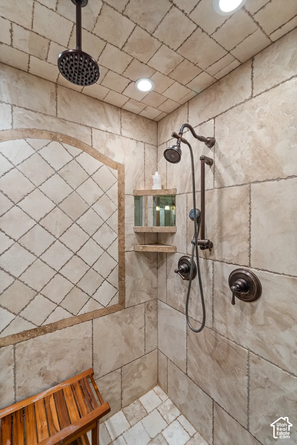 RELAX with this dual shower head system, recessed lighting, and an integrated corner shelf and mirror.