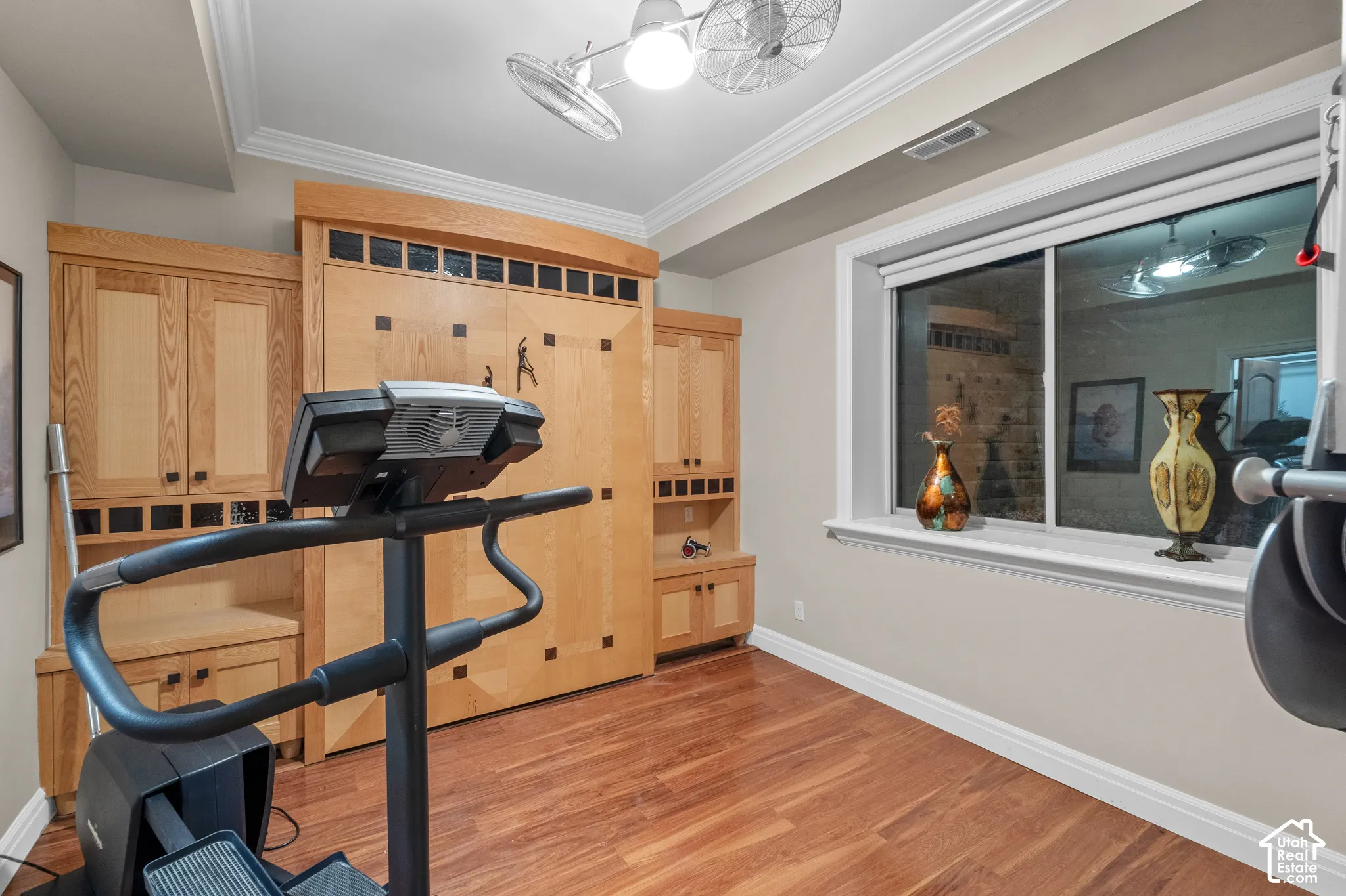 Bedroom number 6, is currently an exercise room but has a huge window for natural light and a built in Murphy bed and walk-in closet for added versatility.