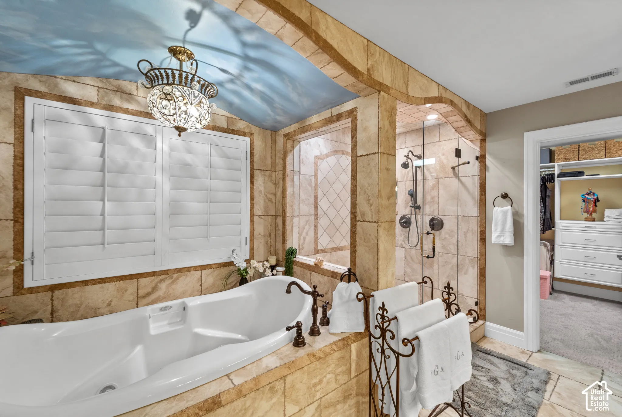 RELAX in the extra deep long tub surrounded by beautiful stone work and a custom painted ceiling.