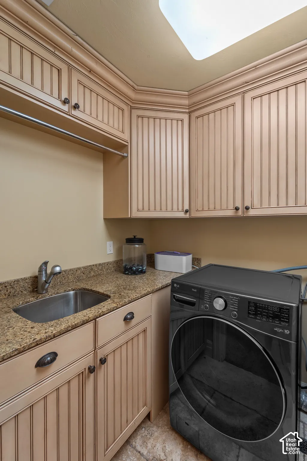 There are two Laundry rooms in this home. This one is on the second floor across from the primary bedroom. You will love the full functionality with an under-mount wash sink, storage cabinets and hanging rod.